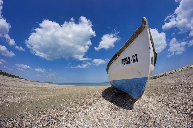 Road sign on beach against sky