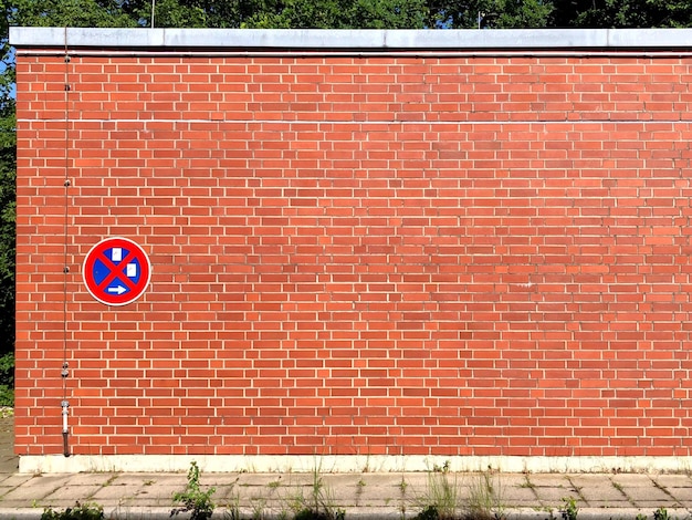 Road sign on brick wall