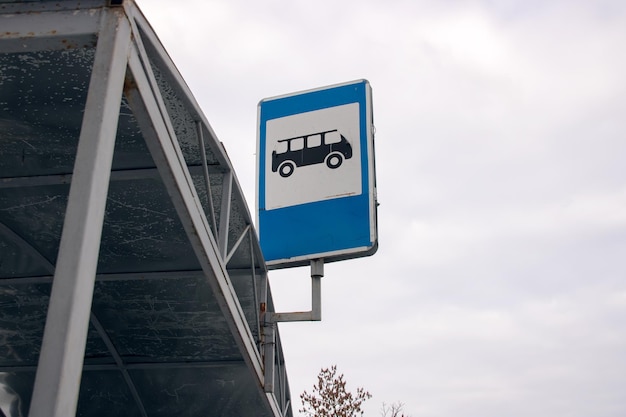 Road sign bus stop on sky background