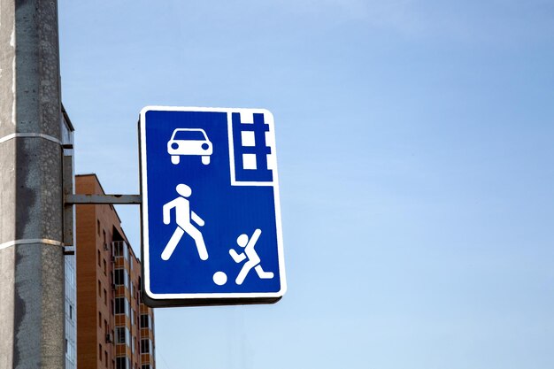 A road sign denoting a residential area against a blue sky with copy space