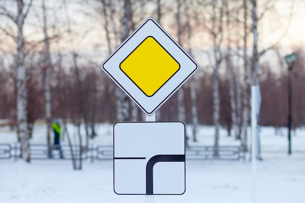 Road sign main road on a children's playground in Russia, winter time. Close up