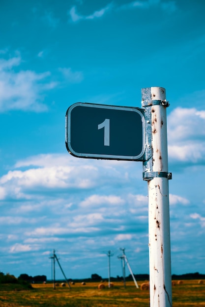 Road sign one kilometer against the blue sky