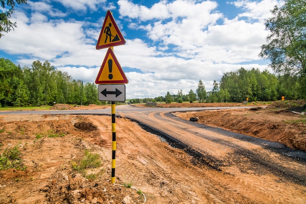 Road signs on a new road under construction