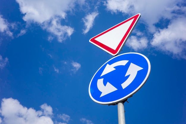 Road signs to regulate traffic give way and roundabout traffic