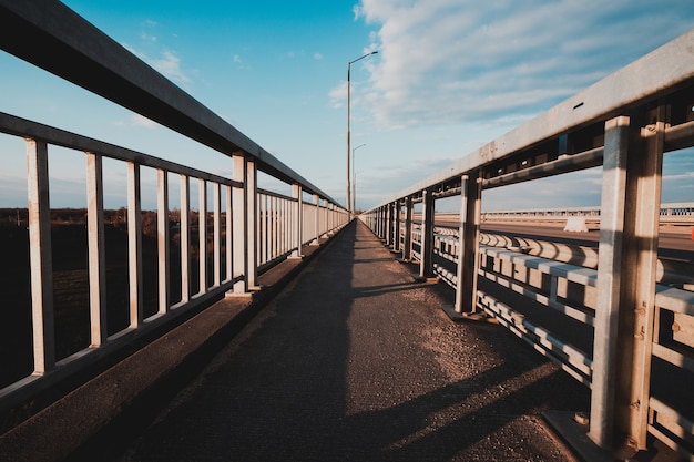 The road stretching into the distance on the bridge, Ukraine, Zaporozhye.