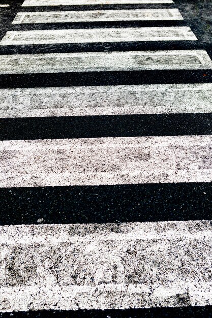 Road surface marking and traffic concept - close up of crosswalk