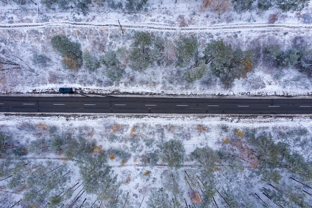 road through winter forest top view drone shooting