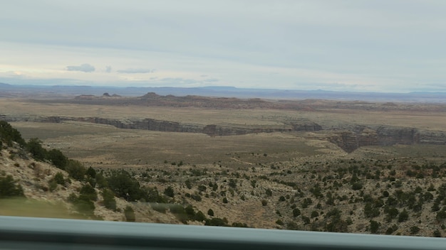 Road trip to Grand Canyon, Arizona USA, driving auto along south rim. Hitchhiking traveling in America, local journey, wild west calm atmosphere, indian lands. Colorado plateau relief thru car window.