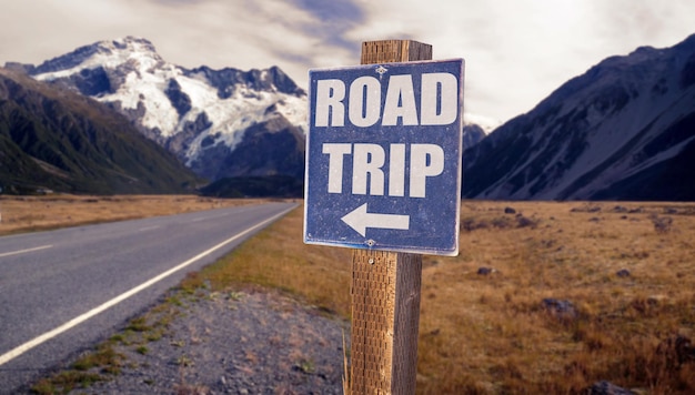 Road Trip sign with road background