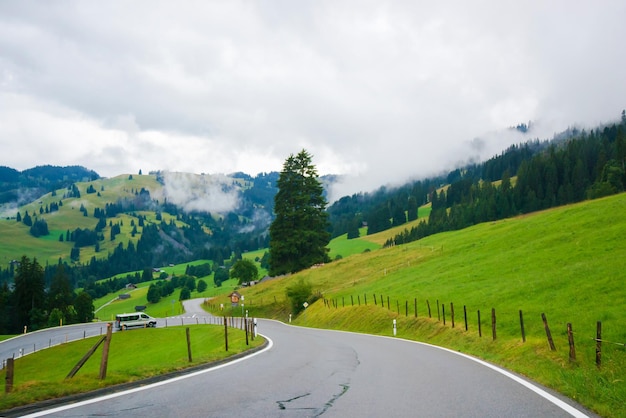 Road in the village of Boltigen with Swiss Alps at Jaun Pass of Fribourg canton in Switzerland.