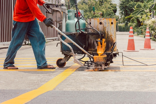 道路作業員がアスファルト路面に動線を描く