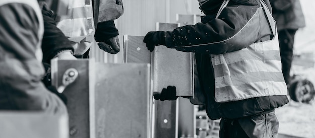 Photo road workers installing a new fence railing of bridge outside the city