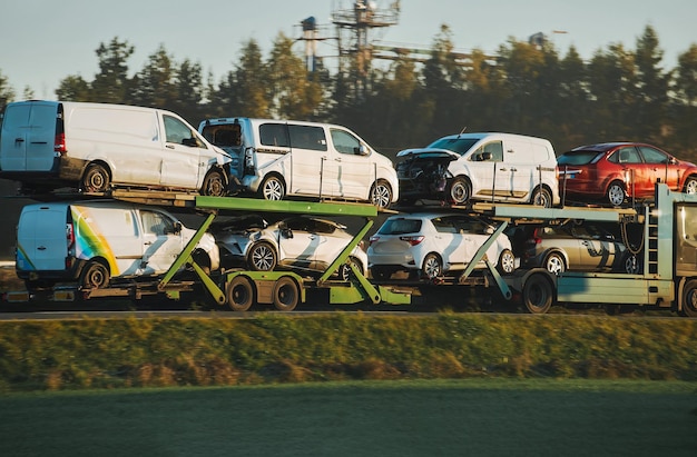 Foto l'assistenza stradale trasporta un'auto con un guasto sulla strada rollback camion di rimorchio un camion di remorchio consegna un veicolo guastato l'aiuto stradale aiuta un conducente in difficoltà