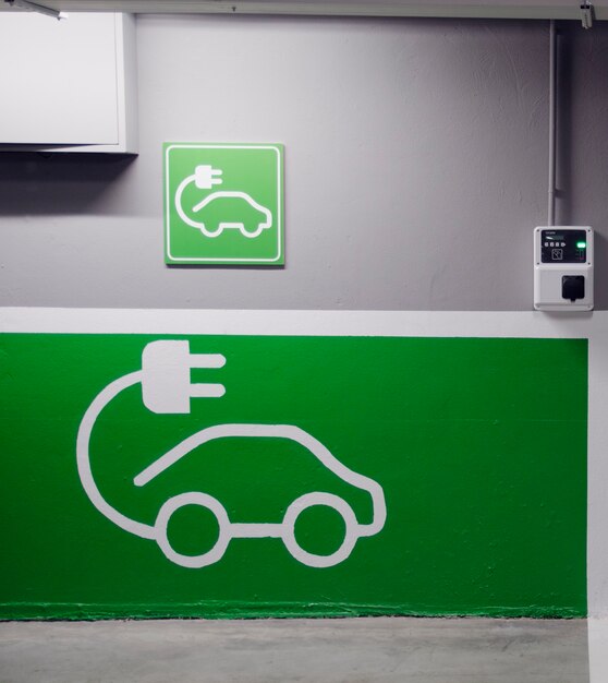 Roadsign of free electric car charging station in a European supermarket parking lot