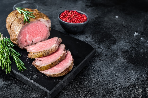 Roast beef fillet Tenderloin meat on a marble board.