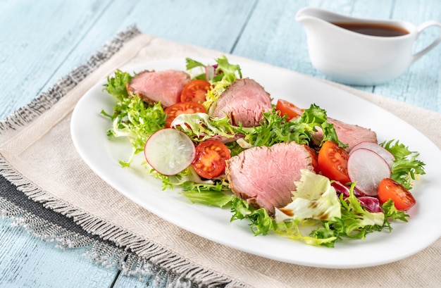 Roast beef salad on the serving plate