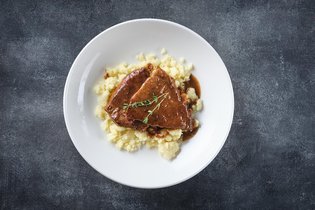 Roast beef smothered in demiglace gravy with mashed potatoes