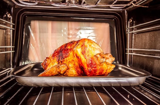Photo roast chicken in the oven, view from the inside of the oven. cooking in the oven. thanksgiving day.
