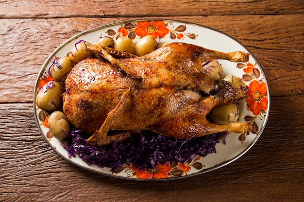 Roast duck with potatoes and purple cabbage