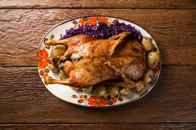 Roast duck with potatoes and purple cabbage