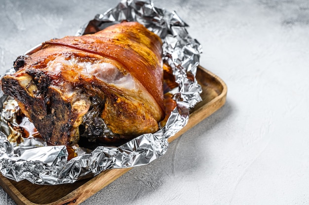 Roast pork knuckle with pepper and spices. Gray background. Top view.