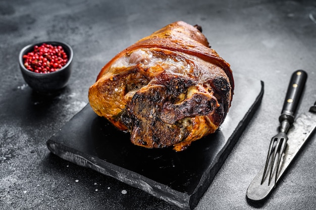 Roast pork knuckle with pink pepper and spices