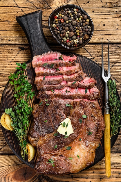 Roast rib eye beef meat steak on a cutting board