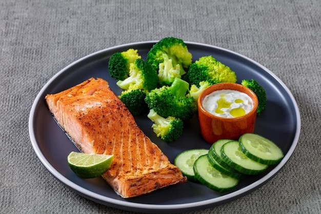 Roast salmon fillet with boiled broccoli and sauce