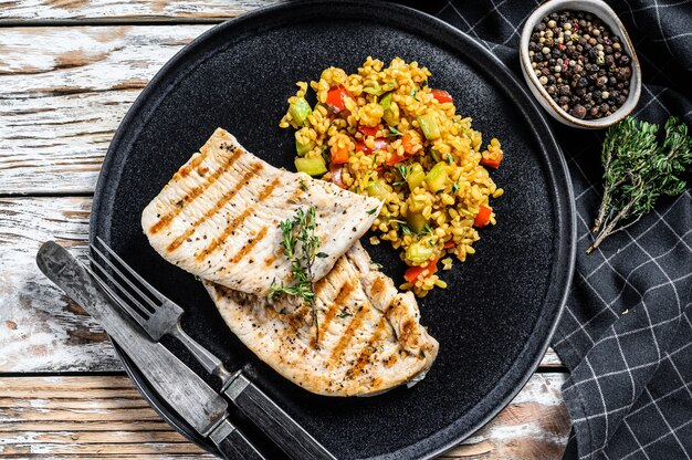 Roast Turkey meat Steaks with quinoa. Top view