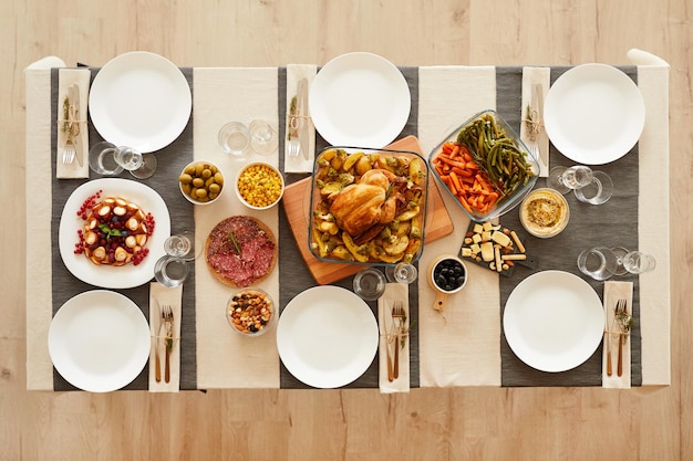 roast turkey in the middle of the table and other dishes ready for family dinner Thanks Giving Day