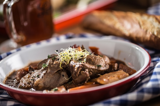 Roast wild boar with carrot mushrooms, baguette and draft beer.