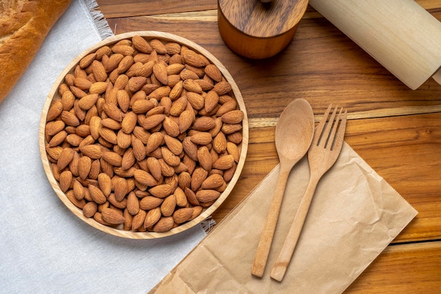 Roasted Almond on wooden table, Almond in wooden plate ready to serve.