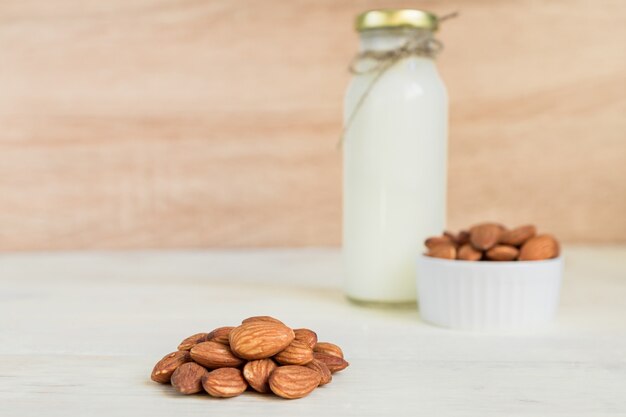 Roasted Almonds in white porcelain bowl on white wooden table