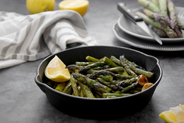 Roasted asparagus in black iron pan.