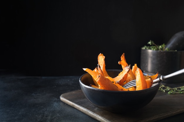 Roasted, baked pumpkin with thyme. Healthy vegan food.