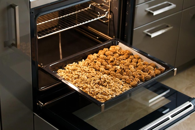 Roasted baked walnuts close up on a baking sheet