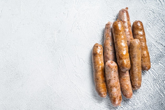 Roasted Bratwurst Hot Dog sausages. White background. Top View. Copy space.
