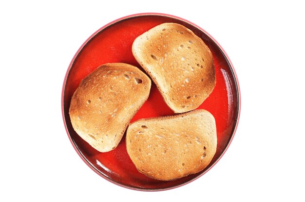 Roasted bread in red plate isolated on white background, top view