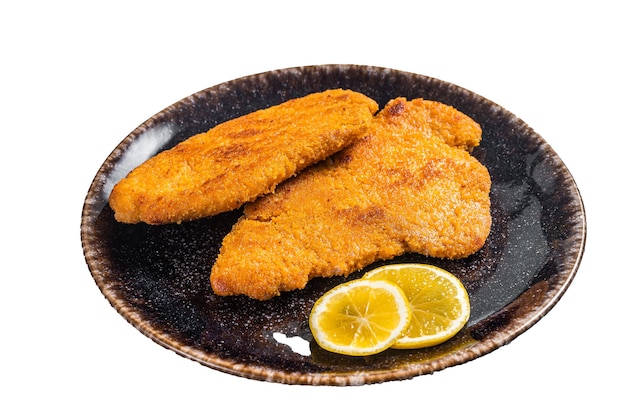 Roasted breaded german weiner schnitzel on a plate Isolated on white background