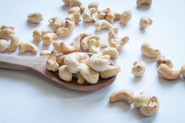 Roasted cashew nuts on white table.