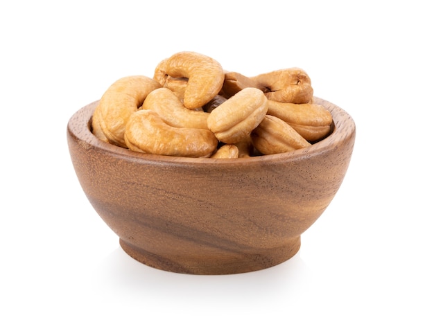 Roasted cashew nuts in wood bowl isolated