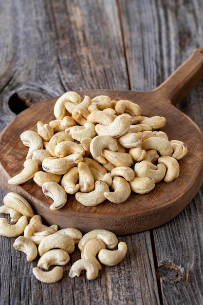 Roasted Cashews Cashew nuts on wood background Bulk Cashews