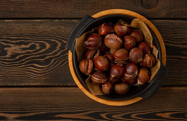 Roasted chestnut on a wooden table no people