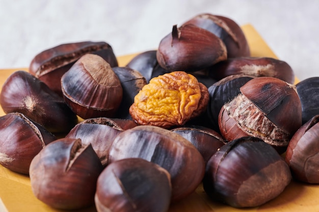 Roasted chestnuts on wooden plate