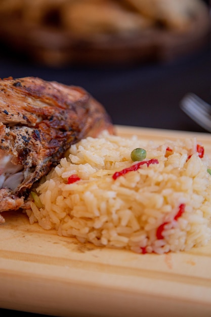 Roasted chicken breast served with rice and vegetables