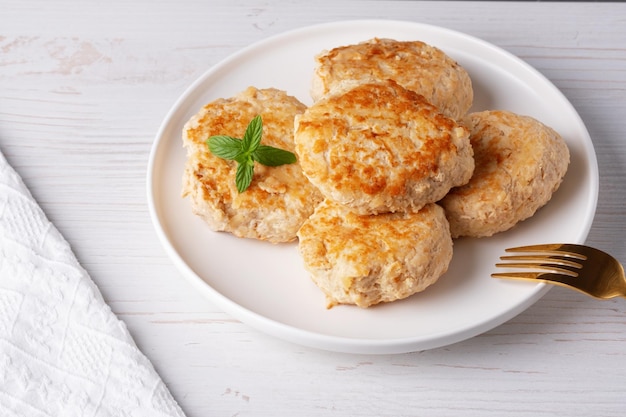 Roasted chicken cutlets on white plate