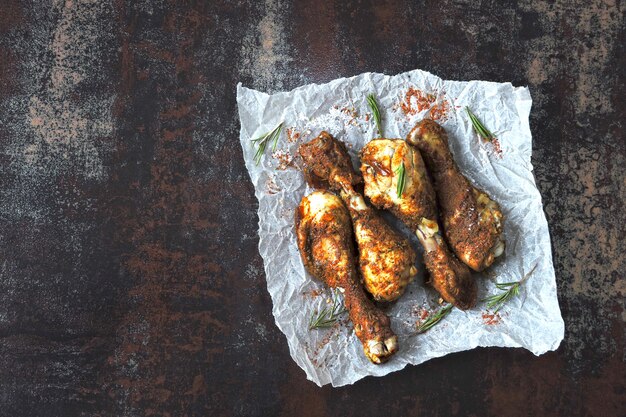 Roasted chicken legs on paper. Grilled chicken legs.