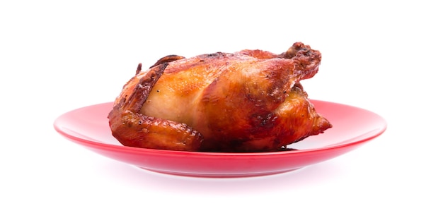 Roasted chicken in plate isolated on white background