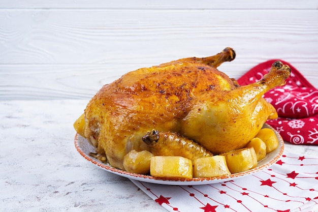 Roasted chicken and potato with Christmas decoration Traditional food for Christmas or Thanksgiving day