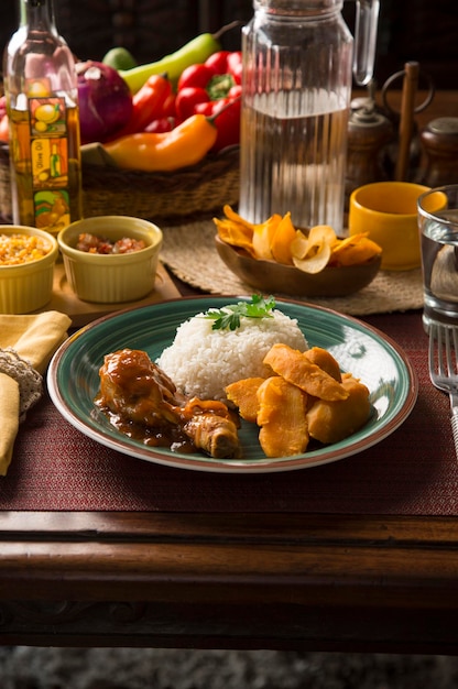 Roasted chicken stew leg with sweet potatoes and white rice Peru peruvian food serving plate